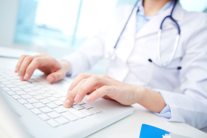 medical worker typing on keyboard